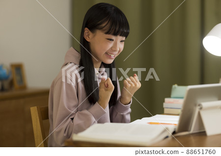 Girl studying while looking at a tablet PC 88651760