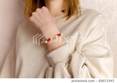 Stylish on the girl arm bracelet decoration made of agate and carnelian. Selective focus Stylish on the girl arm bracelet decoration made of agate and carnelian. Selective focus 88651945