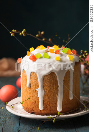 Easter cakes decorated with candied fruit on a wooden background Easter cakes decorated with candied fruit on a wooden background 88652323