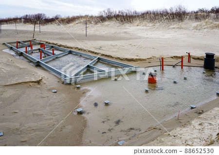 construction of metal beam foundations with communications for seasonal building on the beach construction of metal beam foundations with communications for seasonal building on the beach 88652530