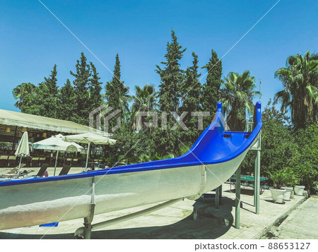 Blue plastic water slide for water sports and fun in the fun aquapark for kids and adults in the tropical resort in the hotel Blue plastic water slide for water sports and fun in the fun aquapark for kids and adults in the tropical resort in the hotel 88653127