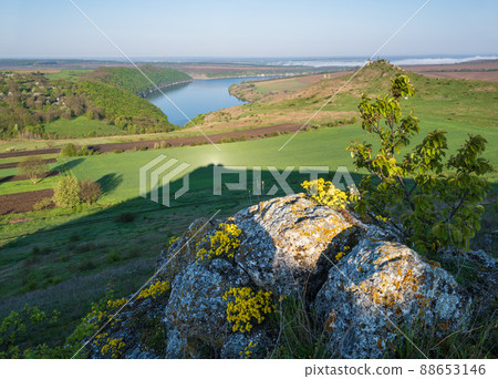 Amazing spring view on the Dnister River Canyon with picturesque rocks, fields, flowers. This place named Shyshkovi Gorby, Nahoriany, Chernivtsi region, Ukraine. Amazing spring view on the Dnister River Canyon with picturesque rocks, fields, flowers. This place named Shyshkovi Gorby, Nahoriany, Chernivtsi region, Ukraine. 88653146