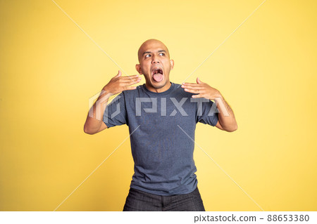 bald young man opening his mouth with spiciness expression 88653380