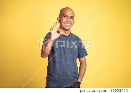 asian bald man showing okay hand gesture with smiling asian bald man showing okay hand gesture with smiling 88653423