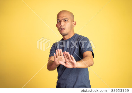 bald man rejecting offer with both palms isolated background bald man rejecting offer with both palms isolated background 88653569
