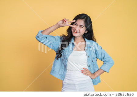 Young asian woman with peaceful hand gesture on isolated 88653686