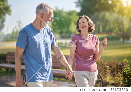 A happy couple in the park feeling good A happy couple in the park feeling good 88653810