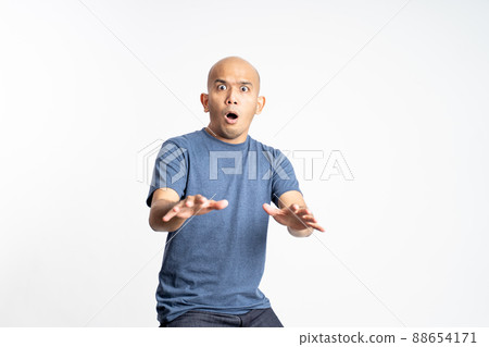 shocked bald man with bulging eyes expression 88654171