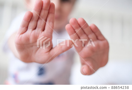 Closeup of childrens hands showing stop sign palms holding forward 88654238