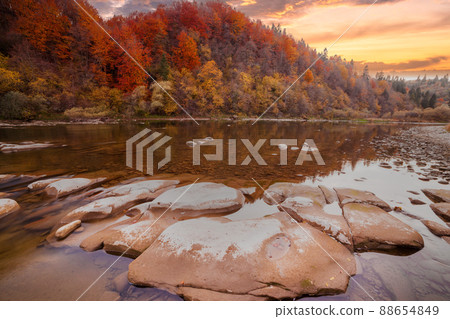 View of the waterfall in autumn. Waterfall in autumn colors. Mountain river in the autumn landscape. Ukraine, river Stryj. 88654849