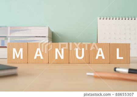 Image of the manual Desk with building blocks with "MANUAL" written on it Image of the manual Desk with building blocks with "MANUAL" written on it 88655307