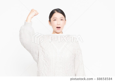 An angry woman with her arms raised 88658584