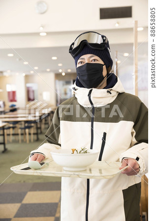 A man in ski suit carrying food with a food code A man in ski suit carrying food with a food code 88658805