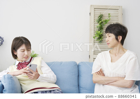 A mother scolding a high school girl's daughter 88660341