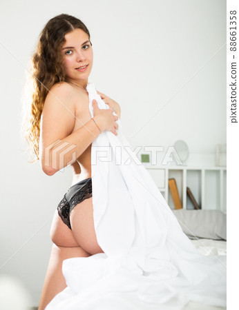 Rear view of cute young girl with long hair in lingerie Rear view of cute young girl with long hair in lingerie 88661358