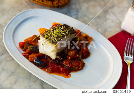Cod confit with vegetable ratatouille on plate 88661459