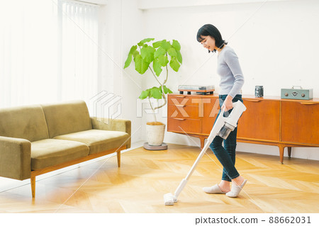 A woman cleaning a vacuum cleaner A woman cleaning a vacuum cleaner 88662031