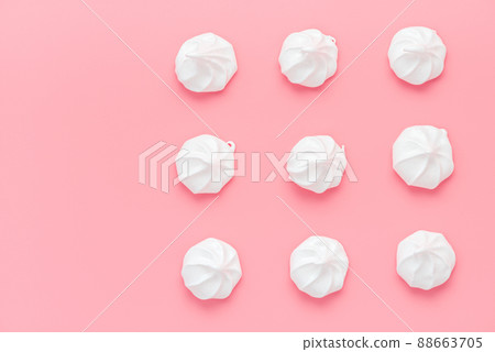 sweet meringue kiss cookies over pink background 88663705