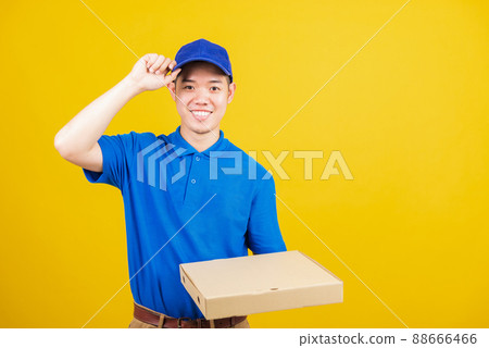 delivery service man standing he smile wearing blue t-shirt and cap uniform hold give food order pizza cardboard boxes delivery service man standing he smile wearing blue t-shirt and cap uniform hold give food order pizza cardboard boxes 88666466