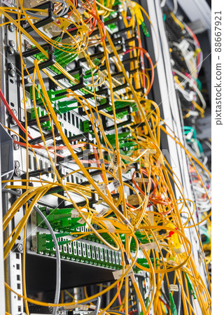 detail of server rack with fiber optic cables attached to front panel switch ports detail of server rack with fiber optic cables attached to front panel switch ports 88667921