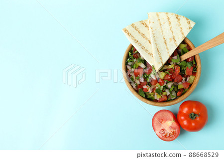Mexican food concept with Pico de Gallo on blue background Mexican food concept with Pico de Gallo on blue background 88668529