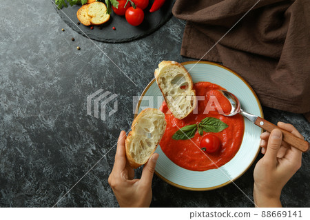 Concept of tasty eating with Gazpacho soup on black smokey background Concept of tasty eating with Gazpacho soup on black smokey background 88669141
