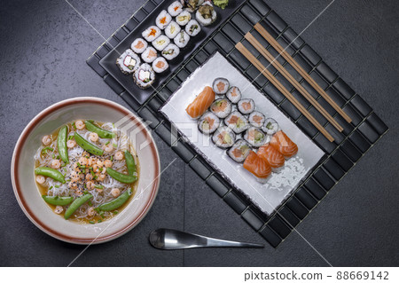 Various dishes of Asian cuisine with typical sushi Various dishes of Asian cuisine with typical sushi 88669142