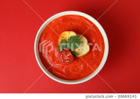 Bowl of tasty Gazpacho soup on red background Bowl of tasty Gazpacho soup on red background 88669143