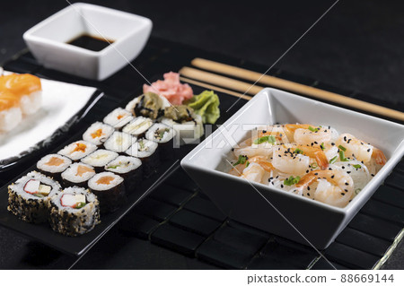 Various dishes of Asian cuisine with typical sushi Various dishes of Asian cuisine with typical sushi 88669144