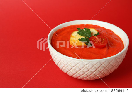 Bowl of tasty Gazpacho soup on red background Bowl of tasty Gazpacho soup on red background 88669145