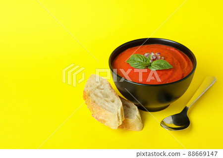 Concept of tasty eating with Gazpacho soup on yellow background 88669147