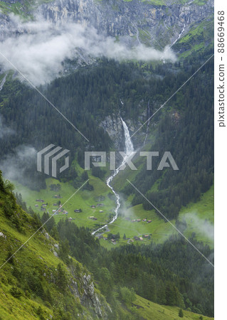 Typical alpine landscape with waterfalls (Niemerstafelbachfall), Swiss Alps near Klausenstrasse, Spiringen, Canton of Uri, Switzerland 88669468