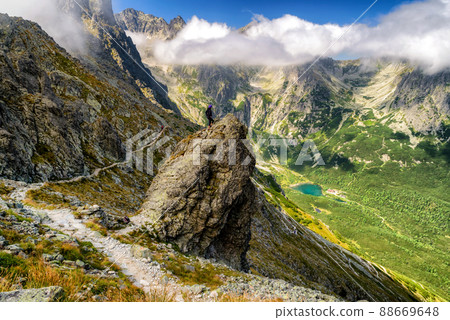 Hiker standing on the hill and looking on mountains 88669648