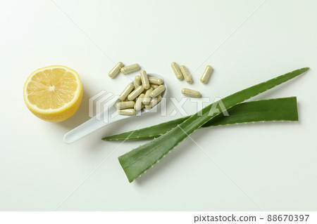 Concept of herb pills with aloe on white background Concept of herb pills with aloe on white background 88670397