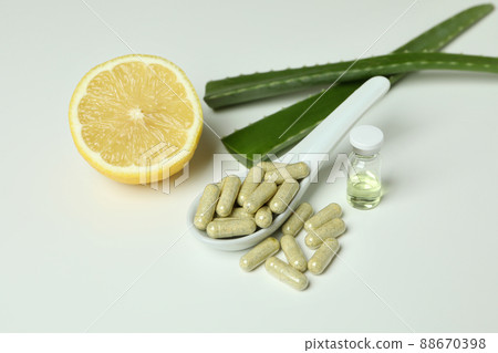 Concept of herb pills and cosmetics with aloe on white background 88670398