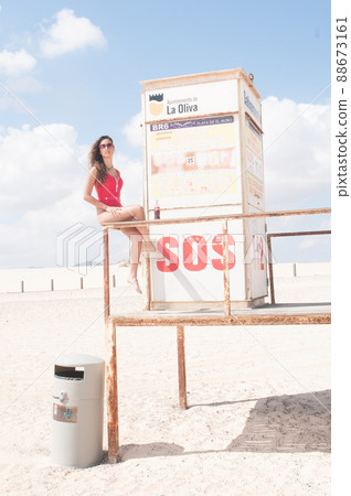 attractive woman in swimsuit in a lifeguard hut on the beach 88673161