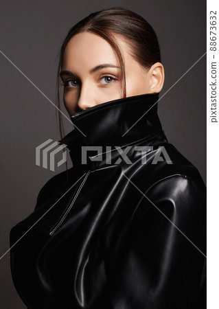 Beautiful woman in leather trench coat Beautiful woman in leather trench coat 88673632