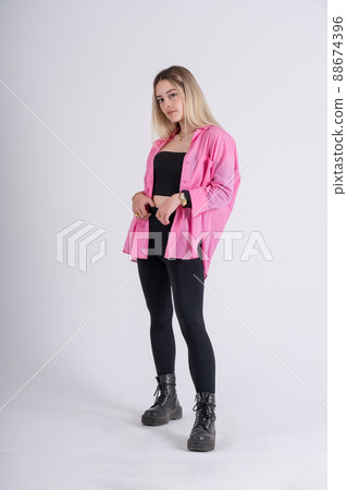 Young blonde standing posing looking at camera 88674396