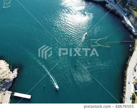 Aerial panoramic view of Balaklava landscape with boats and sea in marina bay on sunny day. Crimea Sevastopol tourist attraction. Drone top view shot of port for luxury yachts, boats and sailboats Aerial panoramic view of Balaklava landscape with boats and sea in marina bay on sunny day. Crimea Sevastopol tourist attraction. Drone top view shot of port for luxury yachts, boats and sailboats 88676503