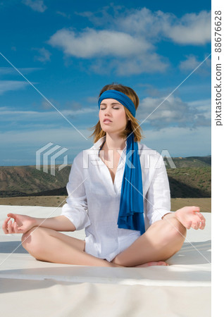 woman under the sky relaxing doing meditation woman under the sky relaxing doing meditation 88676628