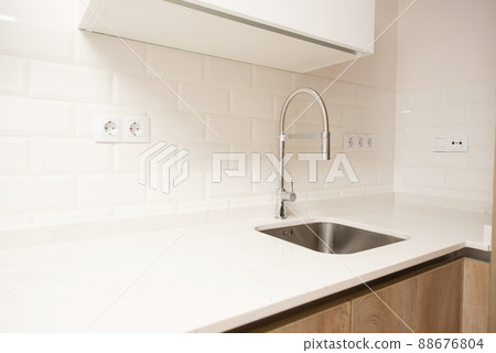 modern kitchen with all its appliances in a home modern kitchen with all its appliances in a home 88676804