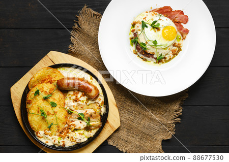 Overhead view of potato fritters with with fried sausage and pork belly Overhead view of potato fritters with with fried sausage and pork belly 88677530