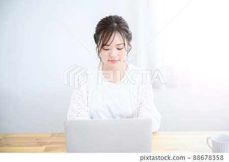 A woman working on a computer at home A woman working on a computer at home 88678358