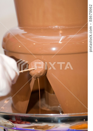 melted chocolate fountain to eat with fruit or treats at a wedding or celebration 88678662