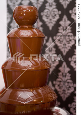 melted chocolate fountain to eat with fruit or treats at a wedding or celebration 88678663