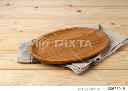 Cutting board with cotton napkin on wooden table Cutting board with cotton napkin on wooden table 88678949