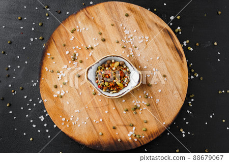 Bowl with spice on wooden board top view 88679067