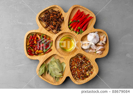 Oil, herbs and spices on wooden background Oil, herbs and spices on wooden background 88679084