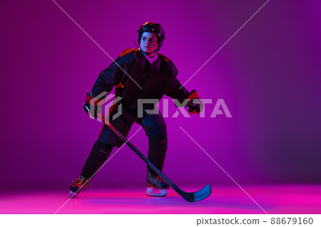 Boy, child. hockey player training isolated over purple background in neon light. Boy, child. hockey player training isolated over purple background in neon light. 88679160