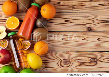 Fruits and freshly squeezed fruits juice on wooden table Fruits and freshly squeezed fruits juice on wooden table 88679238
